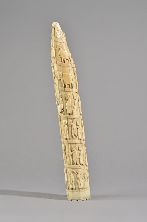 Tribal interest; African carved elephant tusk, late 19th century, carved all over with African natives and titled to the base 'Miss Guest', 35cm, and