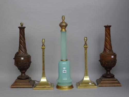 A pair of oak table lamps of carved urn form, 56cm high, an opaline blue glass table lamp on a gilt metal base, 60cm high and a pair of gilt brass tab