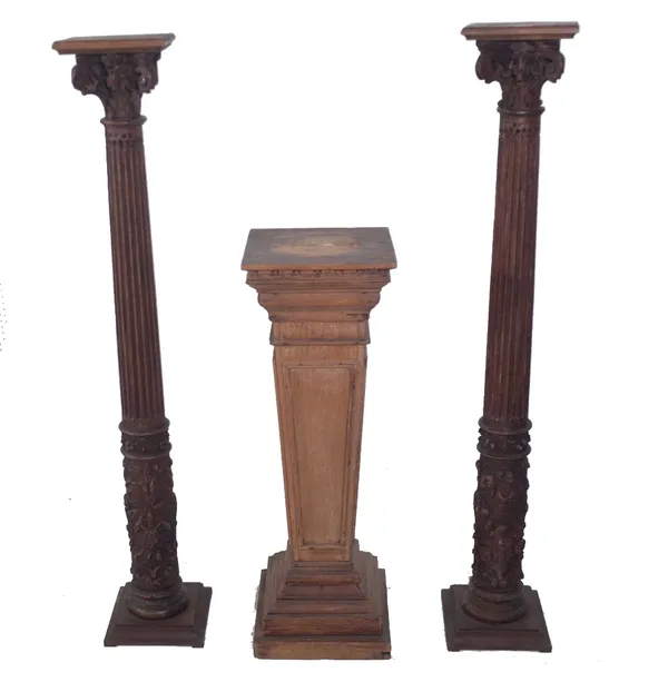 A pair of oak jardiniere stands, late 19th century incorporating earlier elements, each with scrolling capital above fluted tapering column, 21cm wide