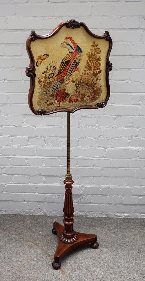 GILLOWS LANCASTER, an early 19th century rosewood framed pole screen, with shaped height adjustable panel on reeded column and melon feet, stamped to