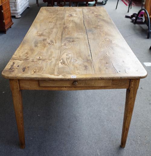 An early 19th century French elm plank top kitchen table, with double end frieze drawer, on canted square supports, 99cm wide x 200cm long.