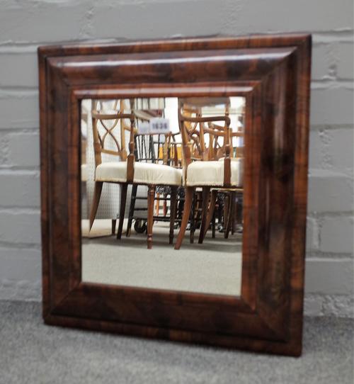 A Queen Anne oyster veneered  cushion frame wall mirror with later bevelled plate, 47cm wide x 51cm high.