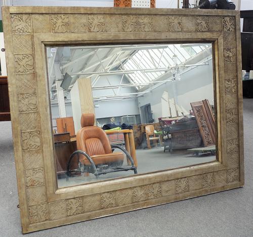 A large 19th century Arts and Crafts wall mirror with wriggle work and stylized leaf moulded frame, 198cm wide x 160cm high.