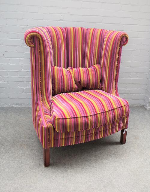 An 18th century style high tub back armchair in striped upholstery, 100cm wide x 108cm high.