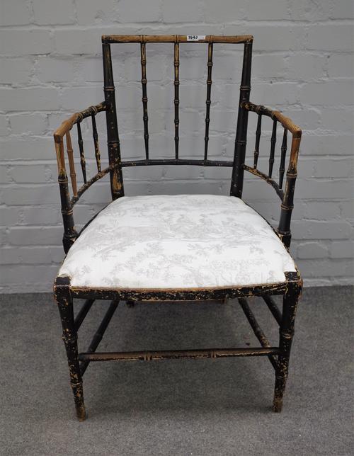A Regency ebonised ash open armchair with faux bamboo turned decoration, 56cm wide x 88cm high.