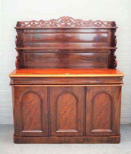 A Victorian mahogany chiffonier, the fret mounted two tier back over cushion drawer and three arch cupboards, 150cm wide x 163cm high. AS