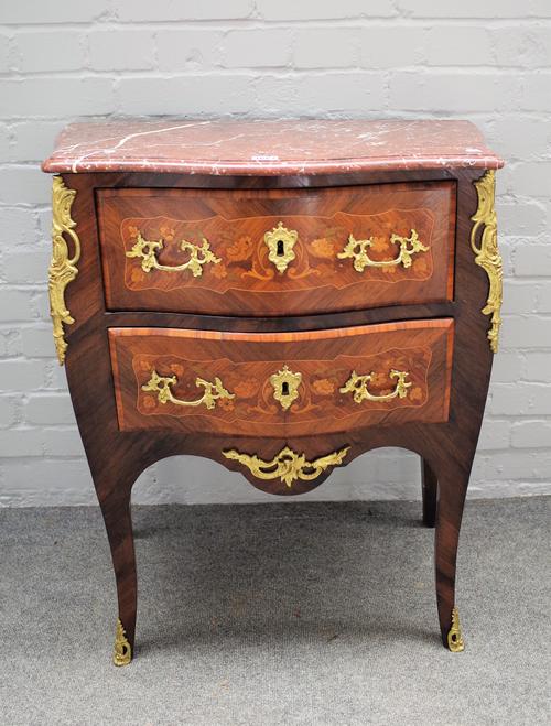 A Louis XV style commode with serpentine marble top, over a bombe gilt metal mounted floral marquetry inlaid kingwood two drawer base on slender cabri
