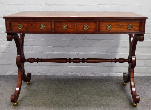 A George III mahogany centre writing table, with three frieze drawers and dummy opposing on 'X' frame supports, 107cm wide x 76cm high.