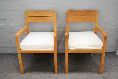 A pair of 20th century beech framed open armchairs, on block supports, 55cm wide x 82cm high.