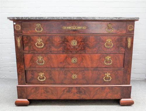 A 19th century French commode, the marble top on a gilt metal mounted mahogany base of five long graduated drawers on ogee feet, 132cm wide x 98cm hig