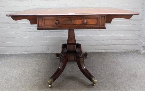 In the manner of Gillows; an early 19th century mahogany drop flap centre table with double frieze drawer on four downswept supports, 89cm wide x 71cm