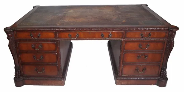 A George III style mahogany twin pedestal partners desk, leather inset top above nine drawers opposed by three frieze drawers above pair of cupboards