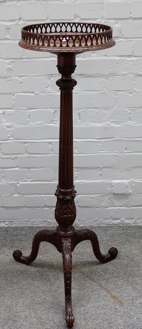 An 18th century style mahogany tourchere stand, the galleried circular top on stop fluted column and carved tripod base, 109cm high.
