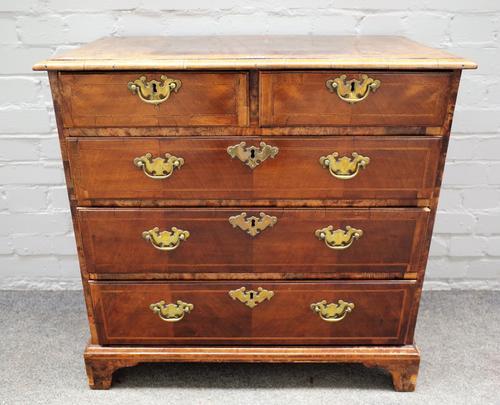 A mid-18th century and later inlaid figured walnut chest with two short and three long graduated drawers on bracket feet, 78cm wide x 77cm high.