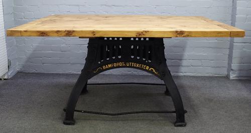 Industrial design oak plank top table on a black painted parcel gilt cast iron base, Bamfords Uttoxeter, 152cm wide x 73cm high.