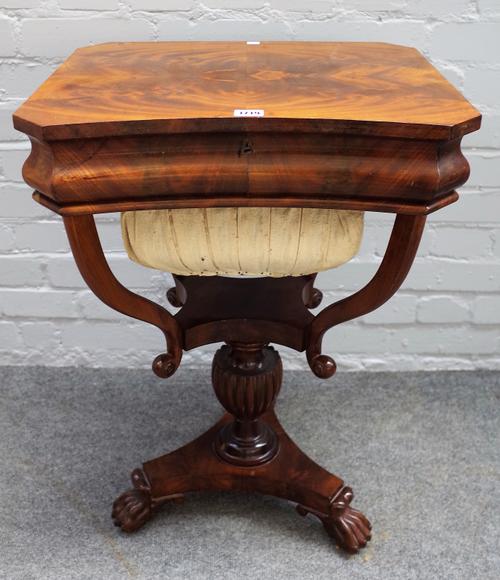 An early 19th century French mahogany work table, the lift top enclosing a fitted interior over wool box on three paw feet, 51cm wide x 73cm high.
