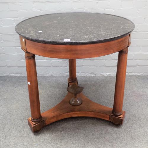 An early 19th century French Empire gueridon/centre table, the dished marble top on  three turned mahogany supports, united by platform, 80cm deep x 7