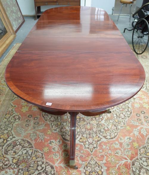 Redman & Hales Ltd, a George III style mahogany triple pillar extending dining table on ten downswept supports, with two extra leaves, 114cm wide x 24