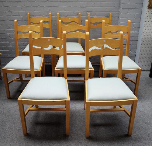 A set of eight beech framed wavy back dining chairs, on block supports, united by sloped stretcher, 45cm wide x 97cm high, (8)