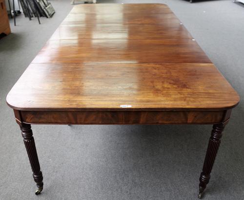 Attributed to Gillows; an early 19th century mahogany extending dining table on spiral fluted supports, with three additional leaves, two associated,
