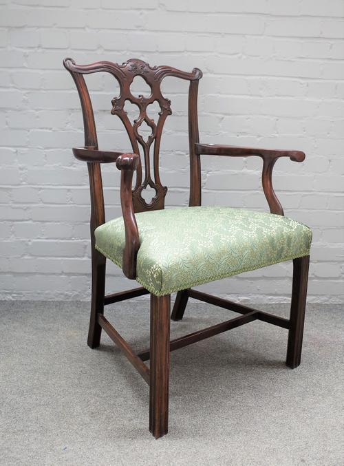 A 19th century mahogany open armchair of mid-18th century design with pierced splat on canted block supports, 71cm wide x 100cm high.