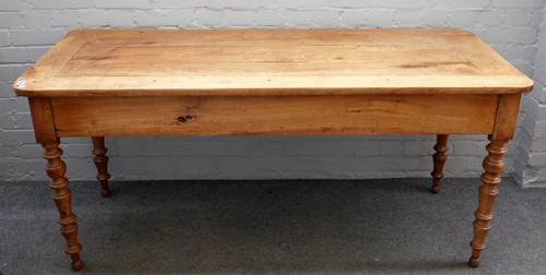 A 19th century French fruitwood plank top kitchen table, with end frieze drawer on turned supports, 71cm wide x 165cm long.
