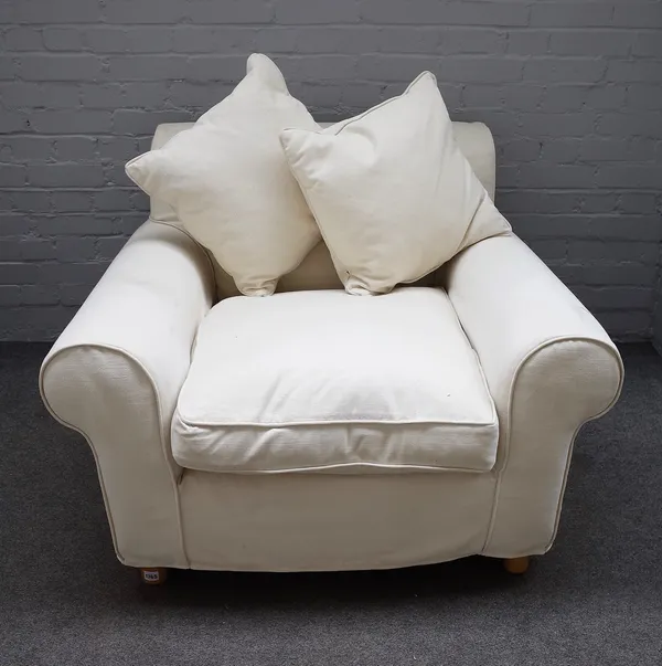 A modern easy armchair with cream loose cover upholstery, 110cm wide x 72cm high, together with a matching rectangular footstool, 100cm wide x 35cm hi