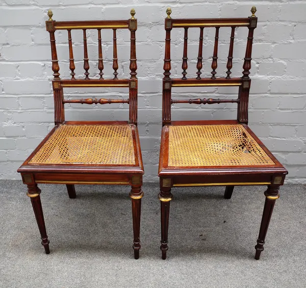 A pair of 19th century French brass mounted mahogany side chairs, with turned backs and fluted supports, 44cm wide x 90cm high, (2).