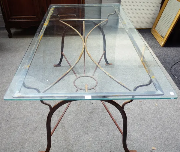 A 20th century wrought iron and glass rectangular dining/ garden table, 90cm wide x 180cm long.