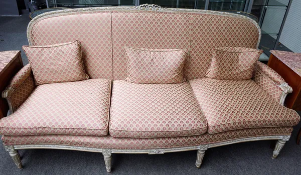 A Louis XVI style limed beech three piece suite to comprise; sofa, 205cm wide x 101cm high, and a pair of armchairs, 70cm wide x 98cm high, all with r