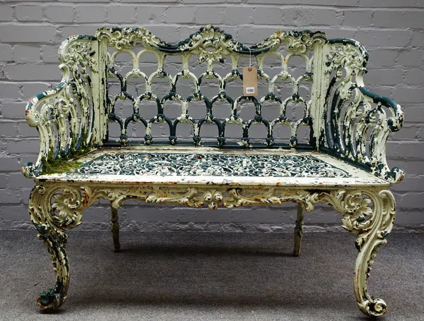 A 20th century green and white painted cast iron garden bench with interlaced arch back on scroll supports, 110cm wide x 90cm high.