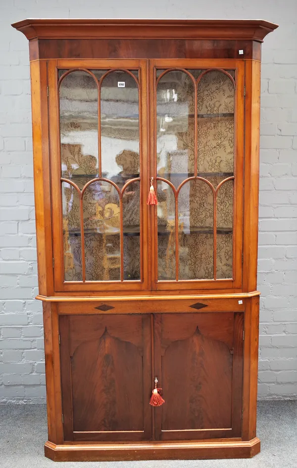 An early Victorian mahogany floor standing corner display cabinet/cupboard with pair of astragal glazed doors over cupboards, 116cm wide x 203cm high.