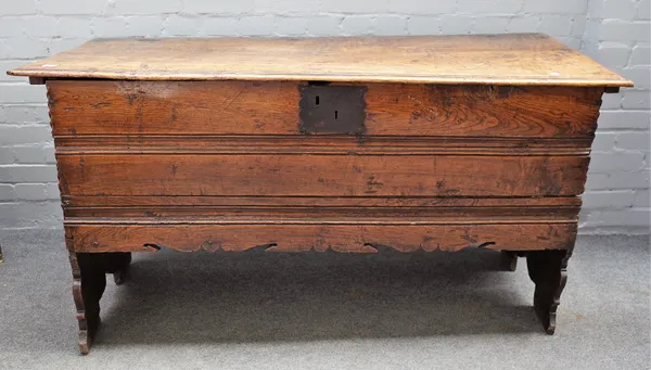 A large 17th century elm coffer, with channelled lid and front, on shaped slab end supports, 150cm wide x 79cm high.