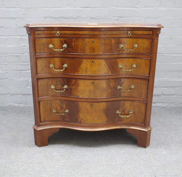 An early 19th century mahogany serpentine chest, the brushing slide over four long graduated drawers on bracket feet, 82cm wide x 81cm high.