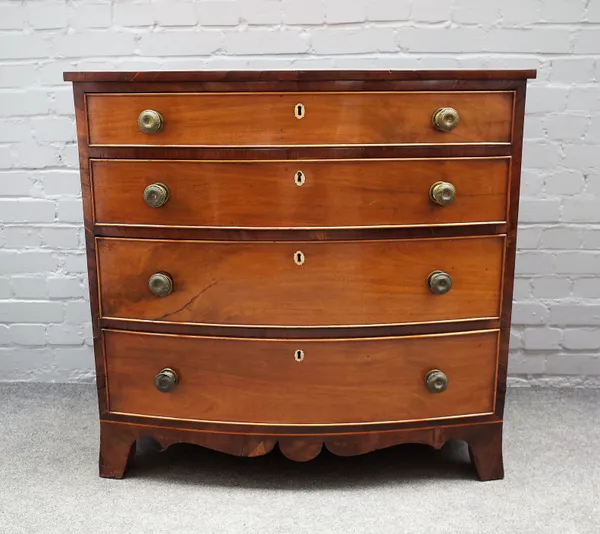 A late Regency inlaid mahogany bowfront chest of four long graduated drawers on splayed bracket feet, 97cm wide x 94cm high.