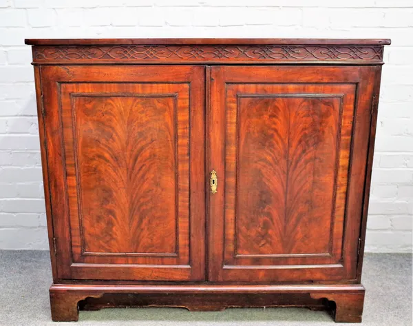 A mid-18th century mahogany side cabinet, the pair of panel doors enclosing a pair of linen trays, 114cm wide x 102cm high.