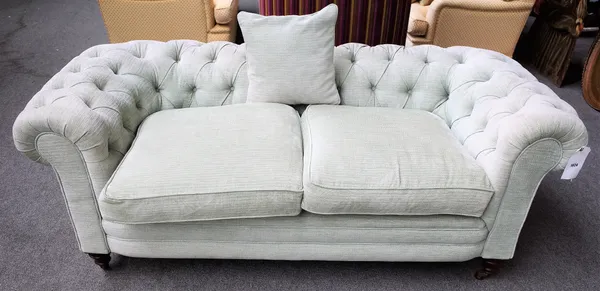 An early 20th century pale teal button back Chesterfield sofa, on bun feet, 180cm wide x 72cm high.