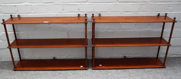 A pair of 19th century mahogany open hanging three tier shelves with turned supports, 61cm wide x 44cm high,(2).