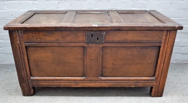 A 17th century oak coffer with triple panel lid and double panel front on stile feet, 119cm wide x 59cm high.