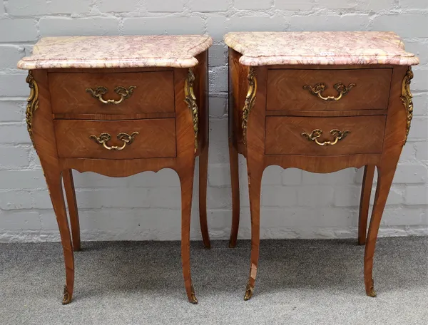 A pair of Louis XV style bedside tables, each with serpentine marble tops over a gilt metal mounted marquetry inlaid kingwood bombe two drawer base, o