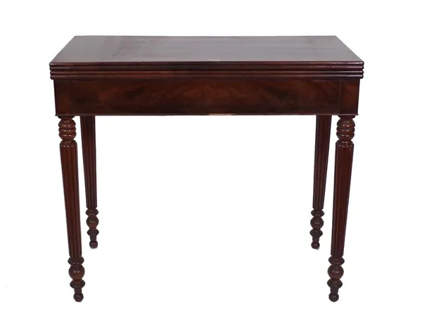 A Regency mahogany foldover card table, on reeded tapering supports, 86cm wide x 43cm deep. Provenance; property from the late Sir David Tang This lot