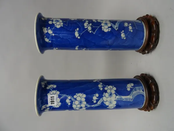 A pair of Chinese blue and white vases cylindrical sleeve vases, late 19th/early 20th century, each painted with prunus on a `cracked ice' ground, 31c