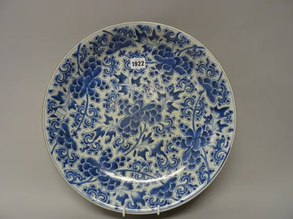 A Chinese blue and white dish, Kangxi, painted with branches of flowering peony, 35.5cm. diameter.