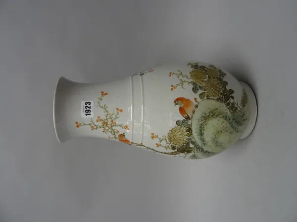 A Chinese porcelain vase, 20th century, of slender pear form, enamelled with two birds in a flowering branch and on a rock, the reverse with lines of