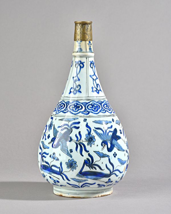 A Persian blue and white rosewater bottle, 18th century, underglaze-blue painted fritware, the ribbed sides painted with cranes and lotus motifs, late