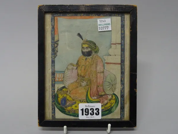 A Sikh portrait of a Sidar, Punjab, 19th century, gouache with gold on paper, seated on a cushion on a European style terrace, indistinct English insc