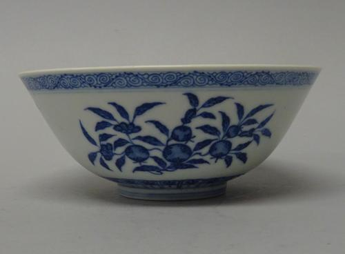 A Chinese blue and white bowl, blue Daoguang seal mark but later, painted on the exterior with branches of fruit, the interior painted with a leafy pe