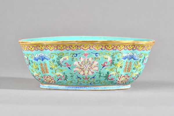 A Chinese famille-rose quatrelobed bowl, iron-red Daoguang mark and probably of the period, painted with lotus flowers alternating with Shou character