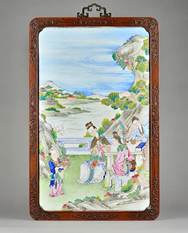 An unusually large Canton enamel rectangular plaque, 18th century, finely painted with three women seated at a table on a terrace, observing a boy sta