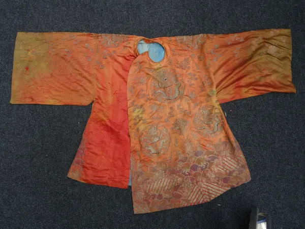 A Chinese orange-ground robe, late19th/20th century, worked with dragon roundels amongst clouds and buddhist emblems above waves.